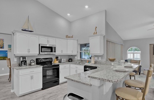 Palm Harbor House | 10 minutes From Beach! Sunny Oasis w Saltwater Pool, Pool Table & Lawn Games!