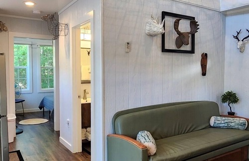 Mill Spring Cabin | 2-story treehouse with a cargo net connecting the upstairs lofts, a large balcony with a slide to the ground level, sleeps 10.