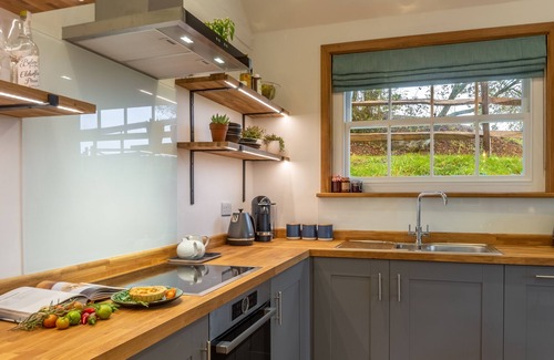Robertsbridge Cottage | A light and airy property with a hammock and hot tub, situated on a working farm
