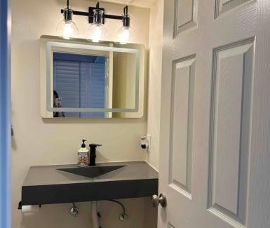 Norwalk House | A small room in the backyard with a full bed