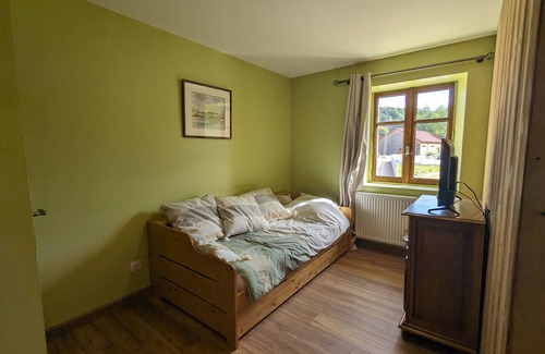 Rehaupal Bed & Breakfast | Air-conditioned family room with garden access