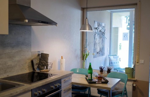 Punderich Apartment | An apartment with a terrace and a roofed balcony, with a view of the Schiefer