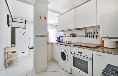 Punta Prima Apartment | Apartment with 2 bedrooms, Wi-Fi, air conditioning, sea view, pool, and garage