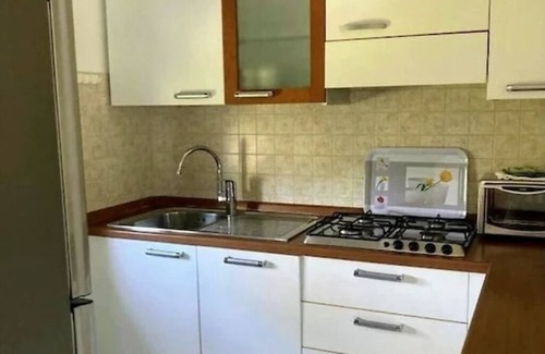 Cisano Apartment | Apartment with panoramic lake view, west-facing balcony, communal pool, 500m to the lake