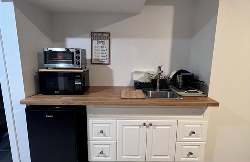 Aylmer House | Basement studio with an attached private bathroom and parking.