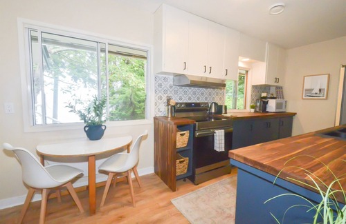 Courtenay House | Beachfront Cottage: Brick Fireplace + Ocean Deck
