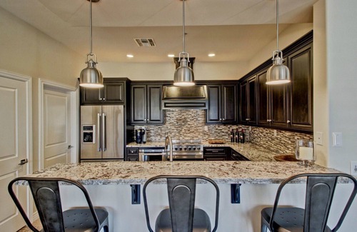 Talon Retreat House | Beautiful RH Furnishings - Custom cabinets with Viking range and refrigerator