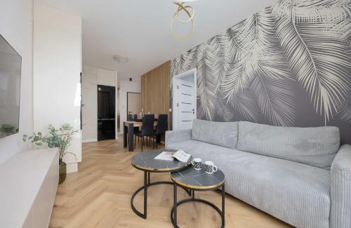 Wlochy Apartment | Beige Apartment in Warsaw with Parking and Air Conditioned Living Room by Noclegi Renters