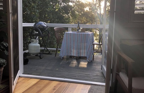 Pretty Beach Apartment | BIRDSONG Stylish private couples loft with water glimpses through the treetops.