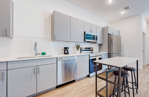 Pecan Springs Springdale Condo | Brand new city escape with pool, trails, game tables, grills, & sky deck