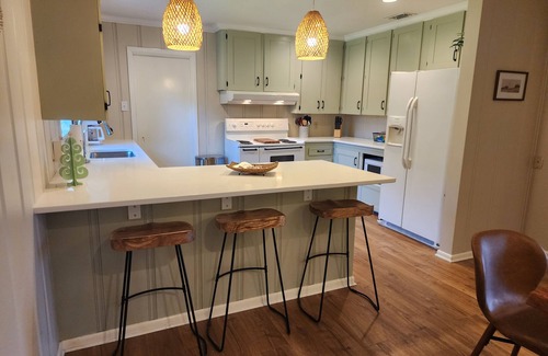 Longview House | Bright and airy Mid-Century Modern home with screened porch and firepit.