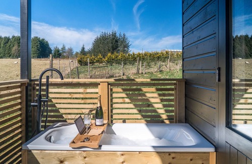 Balfron Cabin | Cabin, with deck and outside bath in woodlands