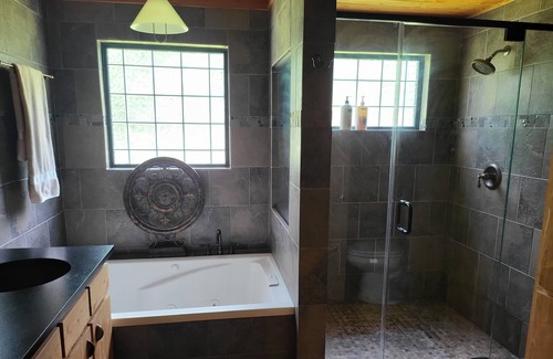 New Ulm Cabin | Cedar Acres offers a 3 Bedroom Log Cabin that overlooks a pond.