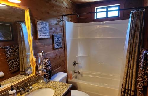 New Ulm Cabin | Cedar Acres offers a 3 Bedroom Log Cabin that overlooks a pond.