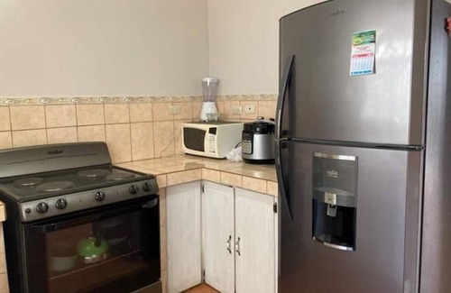 Grecia House | Charming 2-bedroom house with AC and WiFi in a quaint neighborhood.