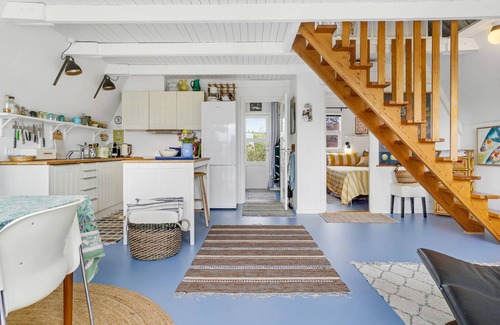 Tørresø House | Charming cottage with fireplace and beautiful view of fields.
