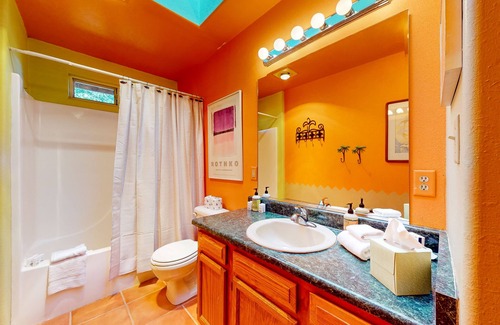 Taos House | Charming secluded home mountain views, covered front porch, & book collection