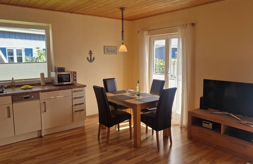 Altefaehr House | Close to the beach holiday home in a quiet field location with a spacious wooden terrace