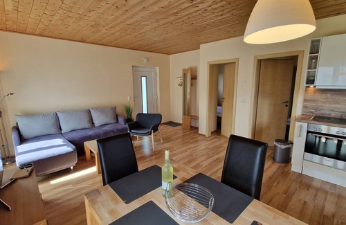Altefaehr House | Close to the beach holiday home in a quiet field location with a spacious wooden terrace