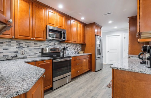 Radford House | Cozy home with a modern kitchen, spacious living, serene bedrooms, and a private deck for relaxation