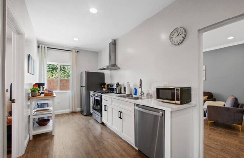 Azusa House | Cozy Urban Retreat: with King and Queen Beds, 1.5 Baths, Well-Equipped Kitchen, Private Backyard, and a Designated Parking Space.