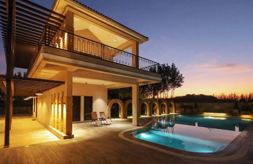 Anjar Villa | Desert Palms by StayVista in Kutch, nestled in orchards, features a swimming pool and a scenic balcony for a serene getaway