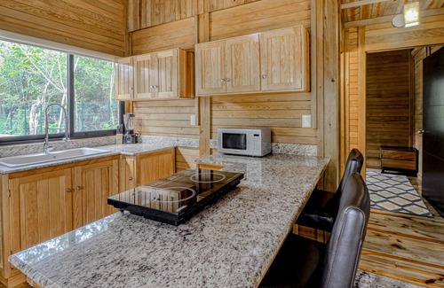 Tulum Cabin | Eco-luxe jungle cabin with furnished patio, lanai, partial AC, & on-site cafe