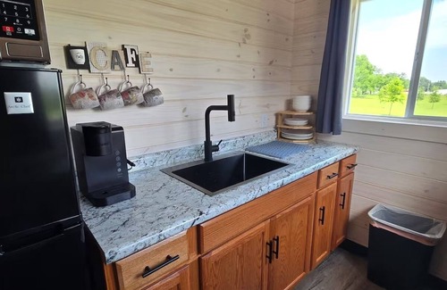 Tuscumbia Cabin | Enjoy cabin #65 at Heritage Acres Park with swimming, splash pad & more!