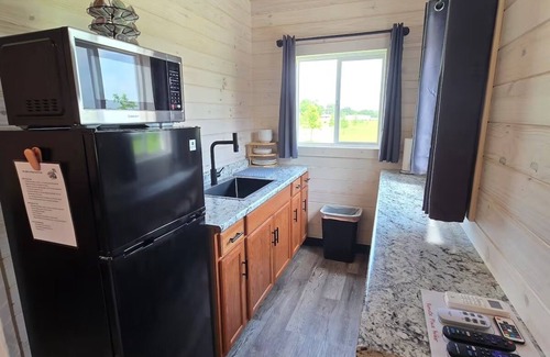 Tuscumbia Cabin | Enjoy cabin #65 at Heritage Acres Park with swimming, splash pad & more!