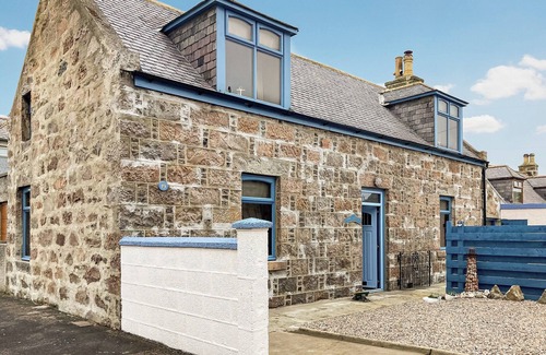 Sandhaven Cottage | Experience cosy comfort in this Cairnbulg holiday home, featuring a log fire.