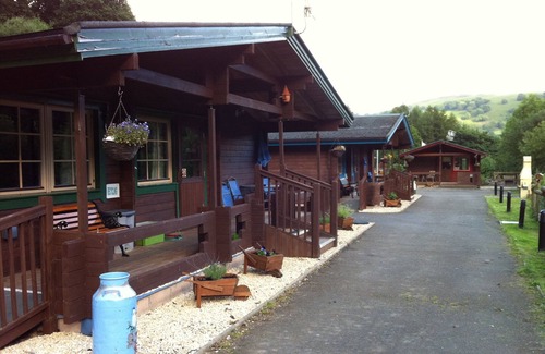 Ynysddu Cabin | Finnish Holiday Lodges, set in wooded hillside, with mountain and stream views