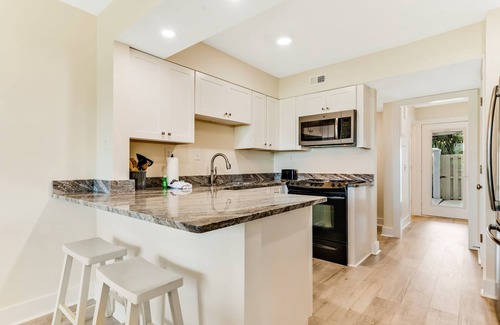 Upper Grand Lagoon Condo | Golf course-adjacent home with shuffleboard table & furnished patio