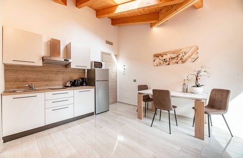 Musso Apartment | Holiday Apartment "Orchidea Terrazzo Sul Tetto" with Balcony, Shared Pool & Wi-Fi
