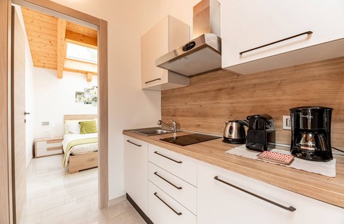 Musso Apartment | Holiday Apartment "Orchidea Terrazzo Sul Tetto" with Balcony, Shared Pool & Wi-Fi