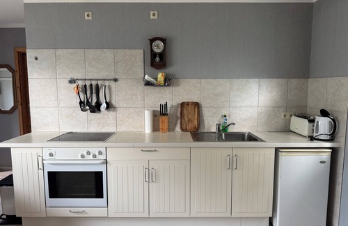 Stuthof House | Idyllic bungalow surrounded by greenery, perfect for relaxing.