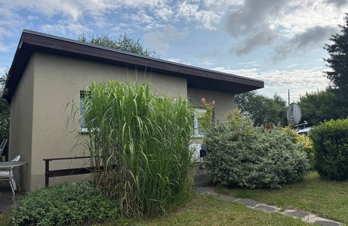 Stuthof House | Idyllic bungalow surrounded by greenery, perfect for relaxing.