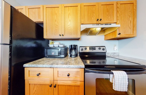 Gilford Condo | Inviting condo in quiet locale with partial lake views, balcony & grilling area