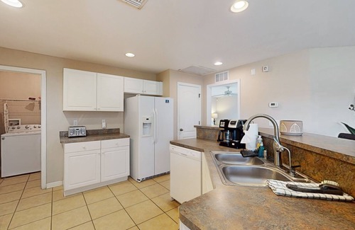 Jacarandas House | Inviting home with screened patio, central AC, full kitchen, & W/D