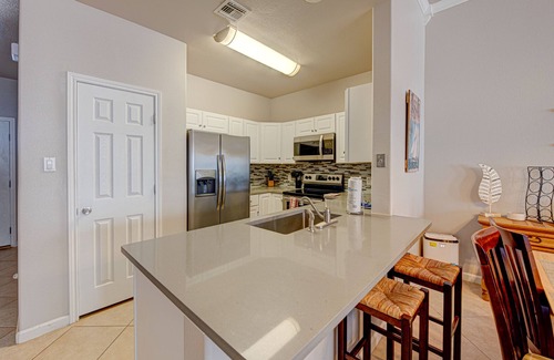 Safe Harbor Condo | Just a few blocks from the beach with a community pool. Sleeps 8!