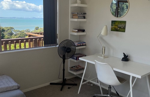 Orua Bay House | La Cachette is a charming Kiwi bach in native bush with stunning harbour views.