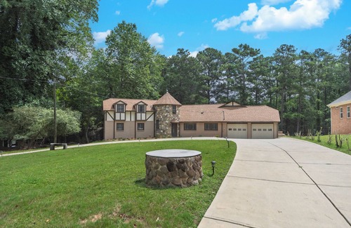 Flowery Branch House | Lakefront 4BR/6BA home with private dock, fire pit, smart TVs in all rooms, sunroom, BBQ grill, and fenced game yard. Includes golf cart, 2 fridges, double oven, and more. 1 mile to Aqualand Marina & Pig Tales Restaurant.