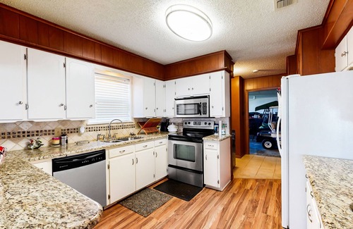 Kemp House | Lakefront retreat near golf course with serene wraparound deck, fireplace, & AC