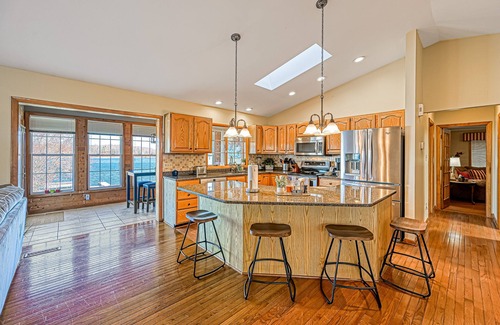 Sandy Point House | Lakefront retreat with a large yard, stone fire pit, gazebo, deck, & dock