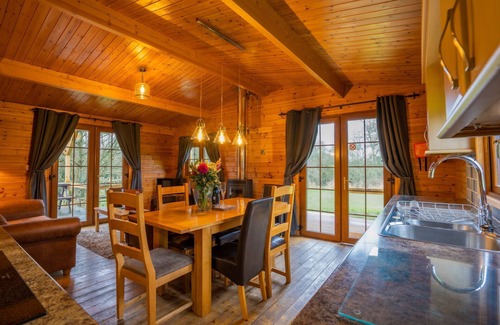 East Huntspill Apartment | Large three bedroom log cabin with private hot tub and decking over looking the beautiful river Brue