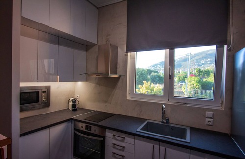 Anavyssos Villa | Lida Garden Vila, featuring a garden with a swimming pool and BBQ facilities.