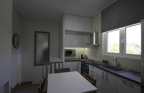 Anavyssos Villa | Lida Garden Vila, featuring a garden with a swimming pool and BBQ facilities.