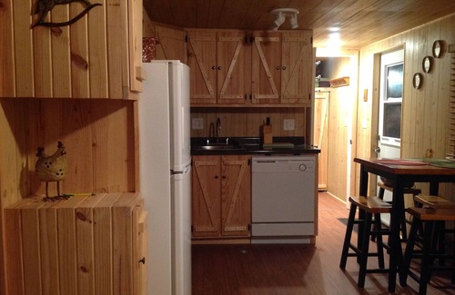 New Plymouth Cabin | Located behind a tree filled garden near our horse barn and Farm Sanctuary.