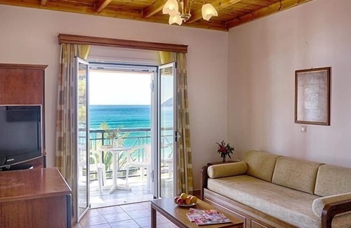 Agios Georgios Pagon Apartment | Maria's apartment 1 - right on the beach with sea views in the beautiful bay of Agios Georgios Pago