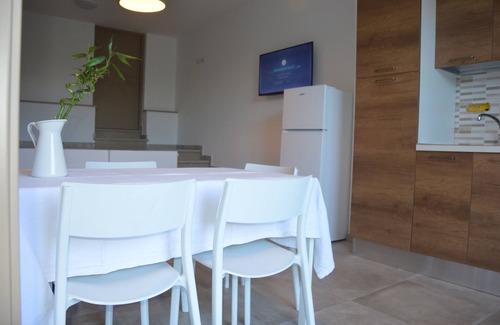 Santa Domenica Apartment | Modern apartment with communal pool surrounded by a beautiful garden