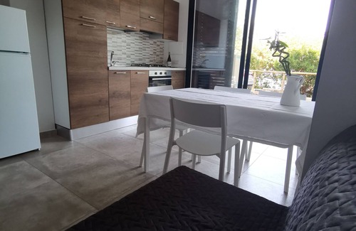 Santa Domenica Apartment | Modern apartment with communal pool surrounded by a beautiful garden